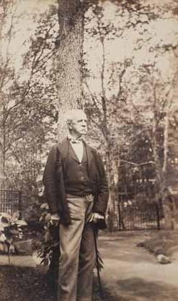 Robert W. Hooper standing outdoors with tree Photograph